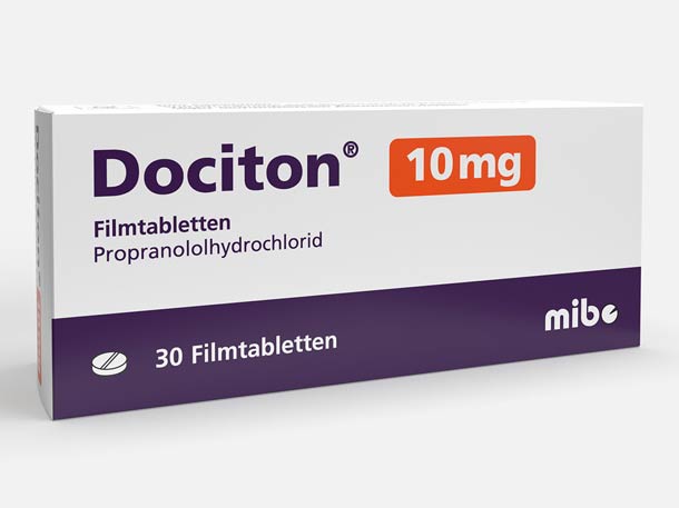 Weiße und dunkelviolette Verpackung der Dociton 10 mg Filmtabletten (Propranololhydrochlorid) von mibe, mit 30 Tabletten.